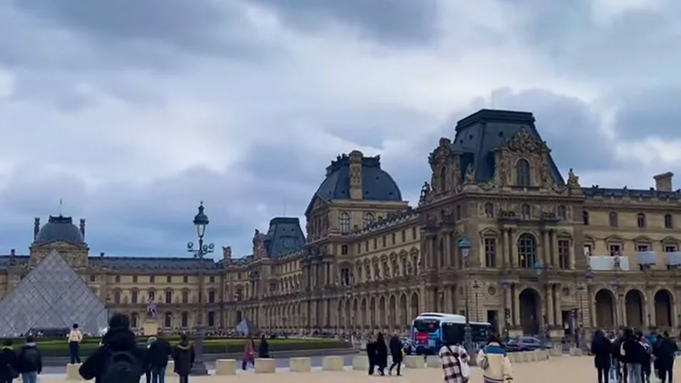Wide view of the Louvre exterior with pyramid and palace wing