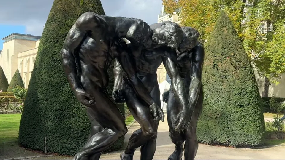 Three Shades sculpture in Musée Rodin garden with topiary and lawn